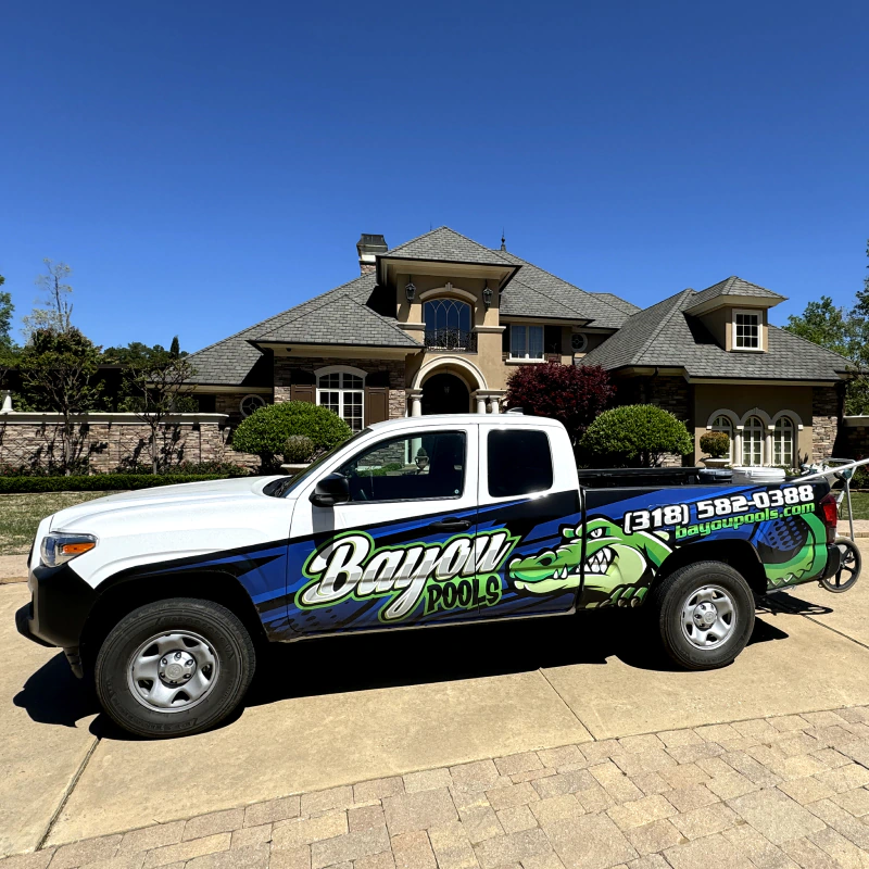 bayou pools service truck in front of luxurious house